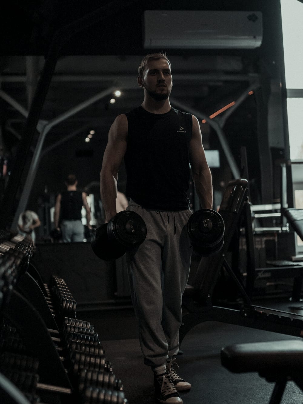 Julien Mercier in a darkened gym under a single directional light.