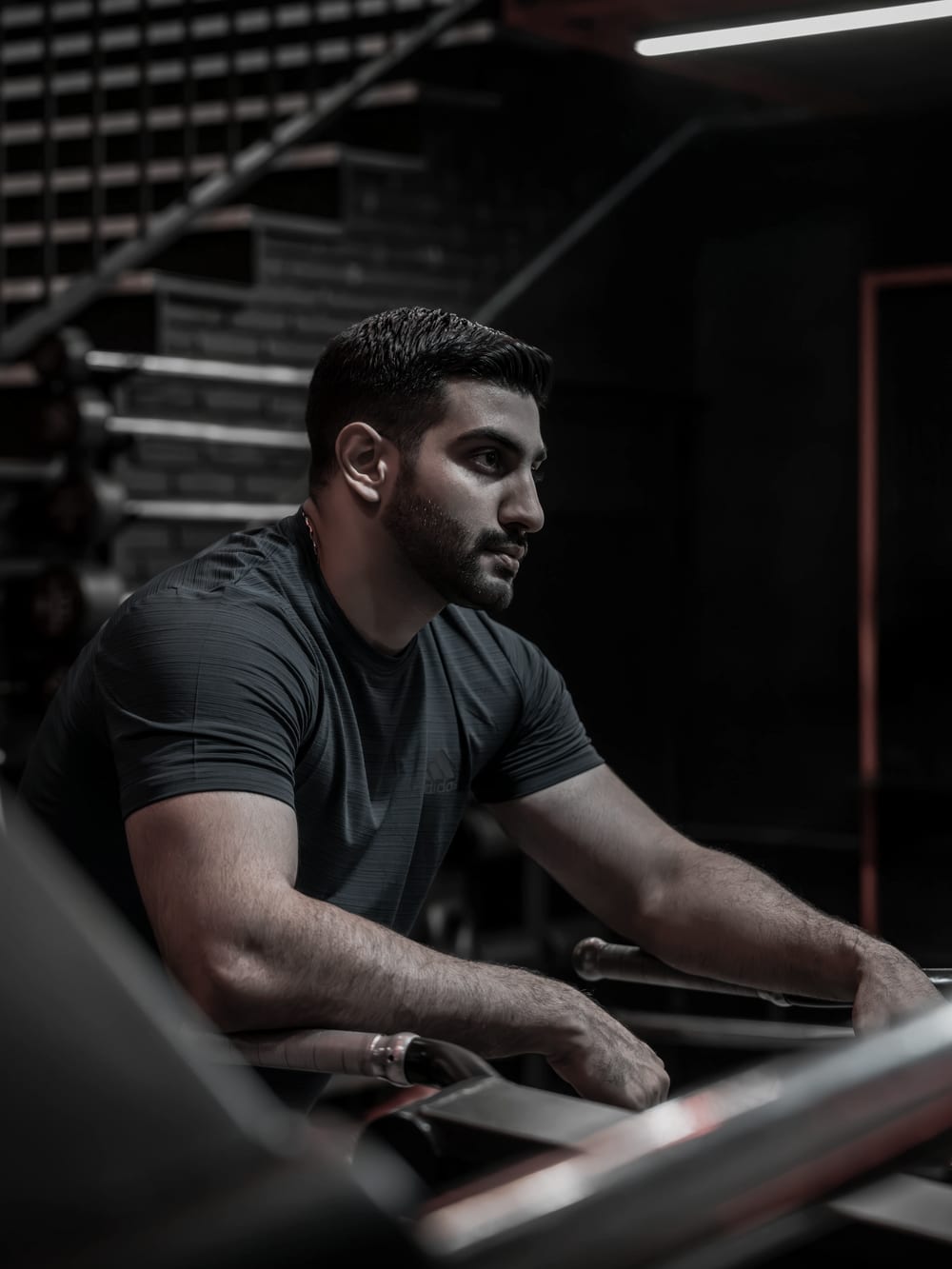 Tomas Novak in a darkened gym under a single directional light.